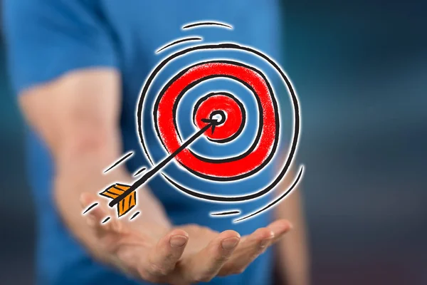 Business target concept above the hand of a man in background