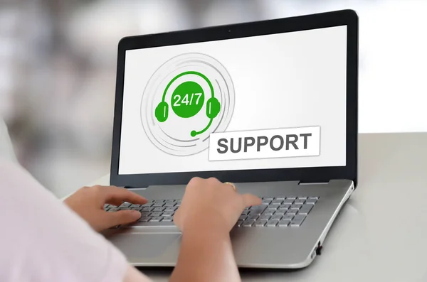 Woman using a laptop with support concept on the screen