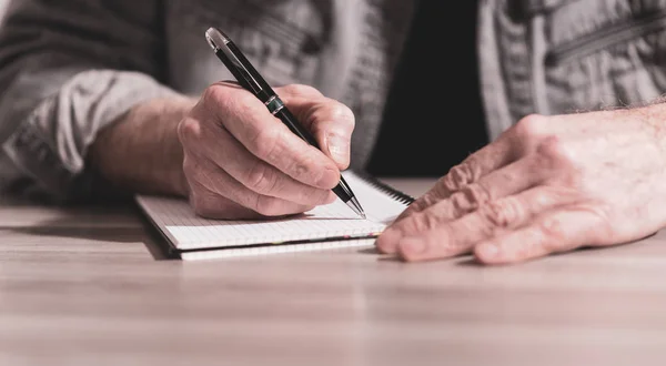 Male hands taking notes