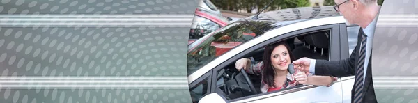 Sprzedawca samochodów dając klucze samochodowe do młodej kobiety. baner panoramiczny — Zdjęcie stockowe