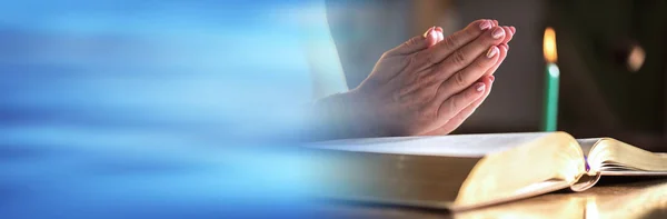 Woman praying with her hands over the bible, hard light. panoram — 스톡 사진