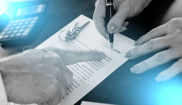 Signature of a real estate contract; light effect — Stock Photo, Image