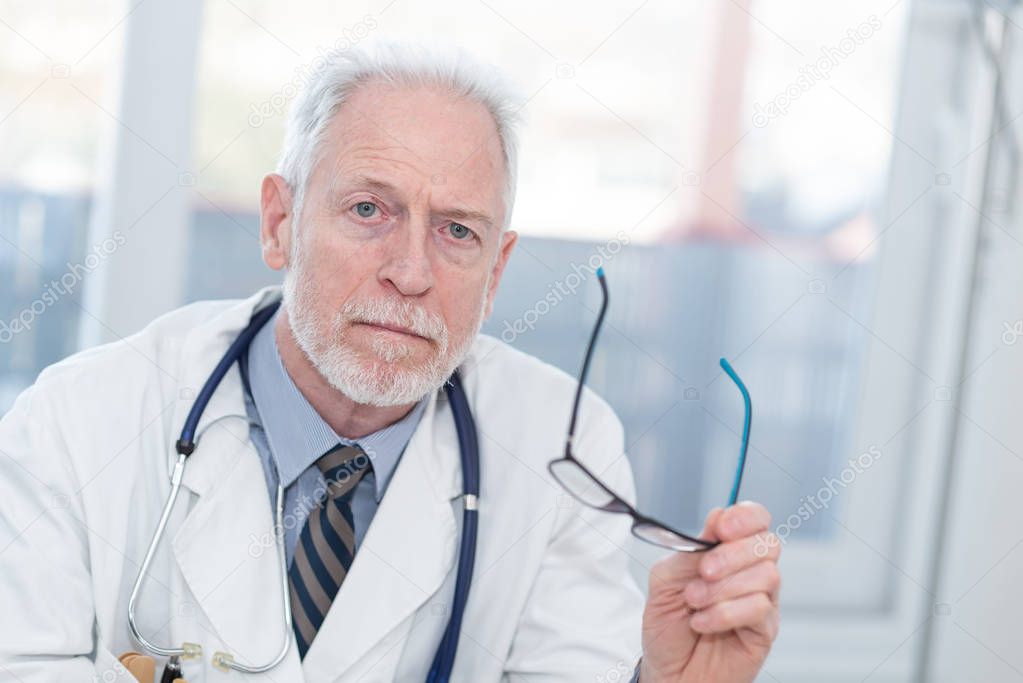 Portrait of male senior doctor