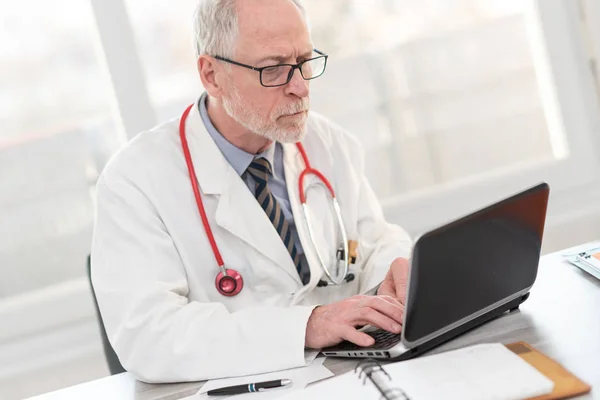 Oberarzt mit Laptop — Stockfoto