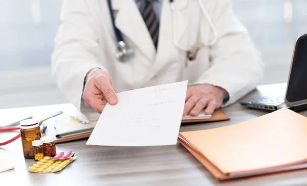 Mano del médico que da una receta — Foto de Stock