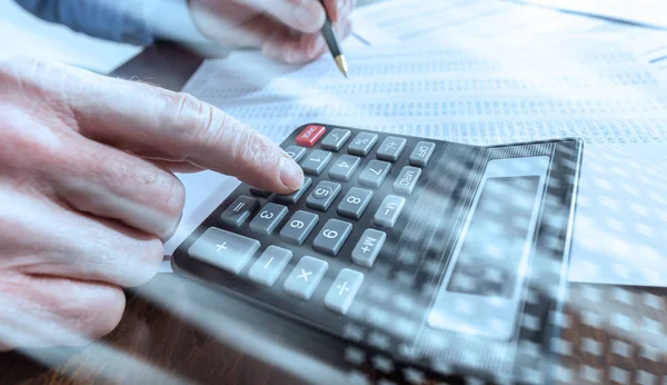 Man doing his accounting; multiple exposure