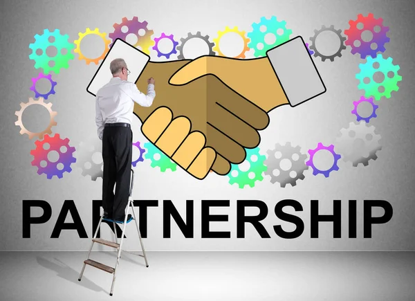 Partnership concept drawn by a man on a ladder — Stock Photo, Image