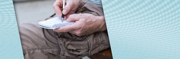 Man taking notes on a pocket book; panoramic banner — Stock Photo, Image
