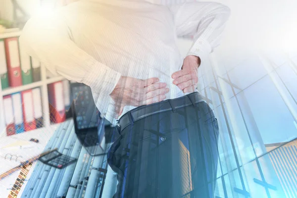 Businessman suffering from back pain; multiple exposure — Stock Photo, Image
