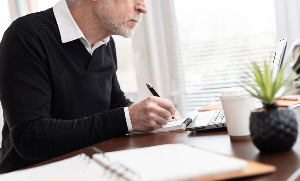 Businessman taking notes on notebook