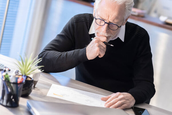 Senior businessman working on document