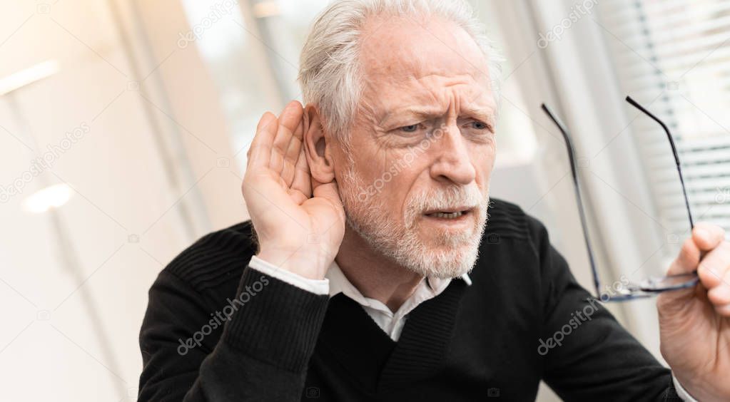 Senior man with hearing problems