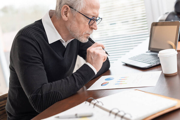 Businessman analysing marketing graphs