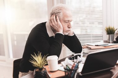 Dağınık masa başında oturan overworked işadamı