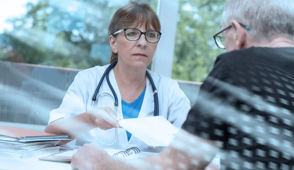 Doctora dando prescripción a su paciente; múltiples exposiciones — Foto de Stock