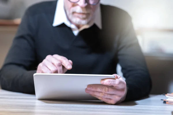 Senior man met zijn tablet — Stockfoto