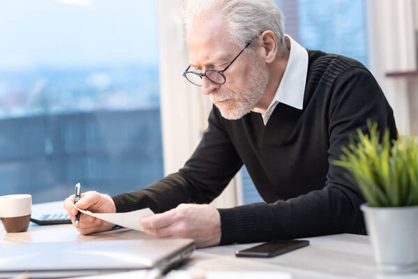 Senior businessman working on document