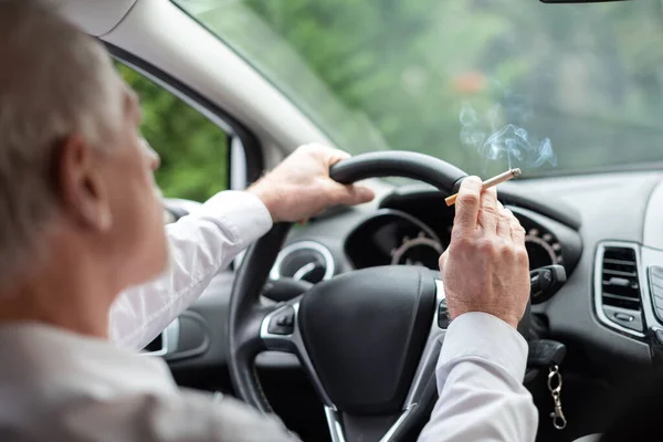 Senior Man Smoking Cigarette While Driving — Stock Photo, Image