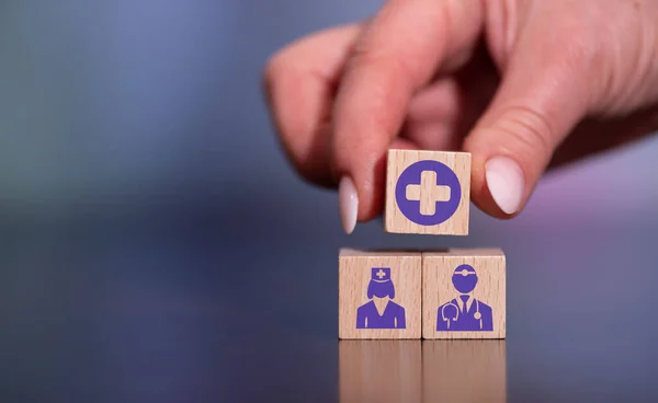 Concept of health staff with icons on wooden cubes