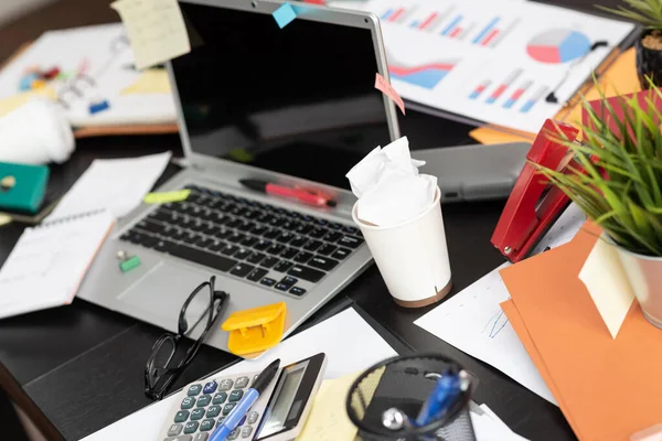 Messy and cluttered office desk