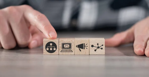 Concept of network marketing with icons on wooden cubes