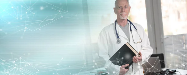 Doctor standing and holding a medical textbook; panoramic banner