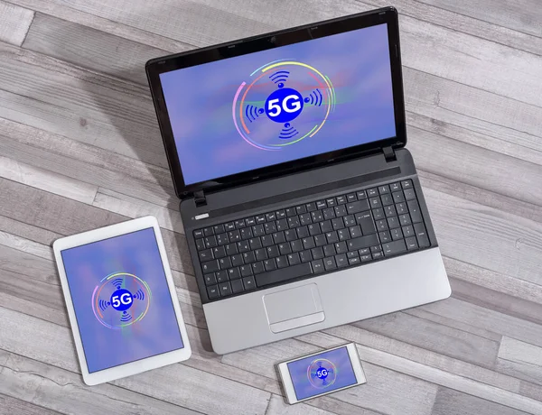 5g concept shown on different information technology devices