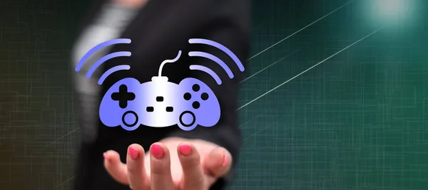 Online gaming concept above the hand of a woman in background