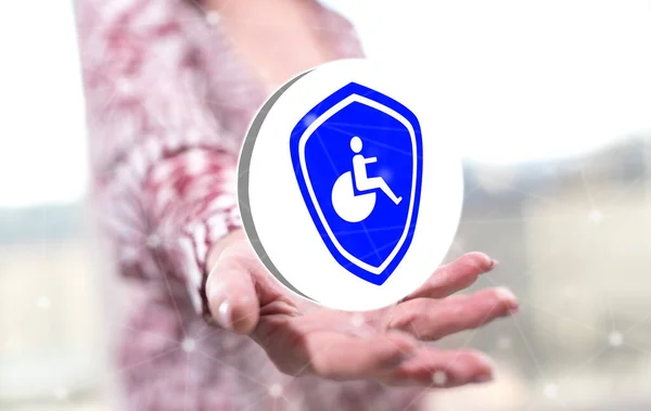 Disability insurance concept above the hand of a woman in background