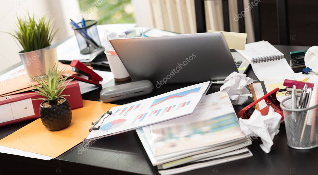 Messy and cluttered office desk