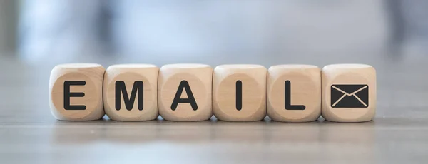 Concept of email sending with icons on wooden cubes
