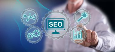 Bir adam dokunmatik ekranda bir konsepte parmağıyla dokunuyor.