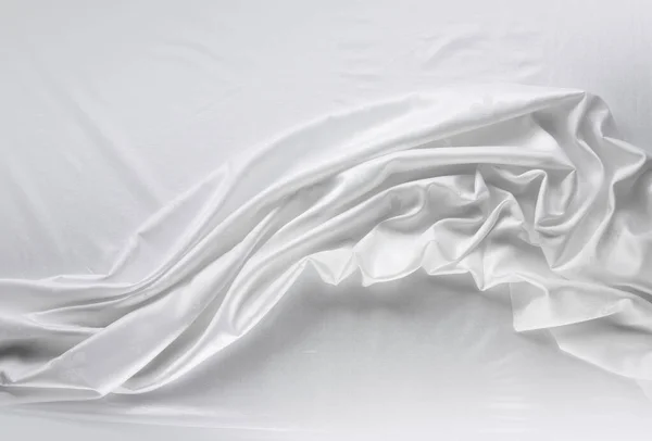 White color cloth. fabric floating. white cloth on the table flowing. Flowing fabric. the curtain is on the table. the silk cloth. white silk fabric. Backdrop