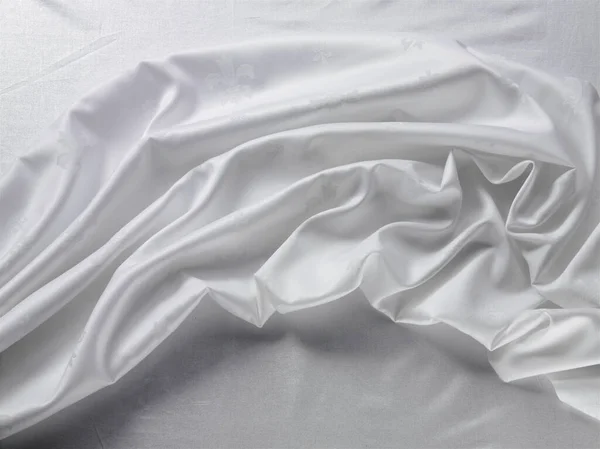 White color cloth. fabric floating. white cloth on the table flowing. Flowing fabric. the curtain is on the table. the silk cloth. white silk fabric. Backdrop