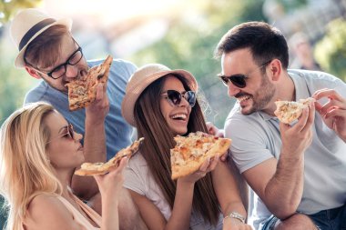 dört genç insanların pizza açık yemek