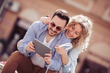 Kaç şehir parkta otururken birlikte müzik dinlemek. İnsanlar, sevgi, müzik ve mutluluk kavramı.