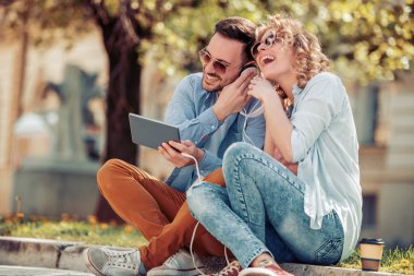 Sokakta müzik dinlerken eğleniyor mutlu genç çiftin yakın çekim.