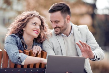 Dizüstü bilgisayar ile şehrin geri kalan sahip güzel romantik çift. 