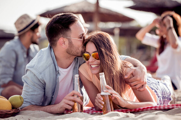 Portrait of happy couple together on the beach,having fun.