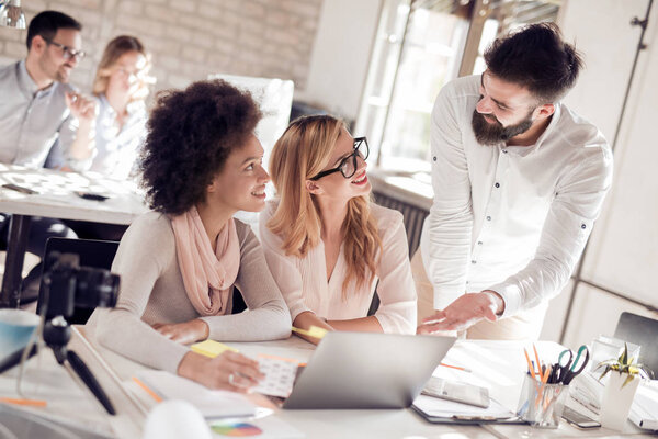 Image of business partners discussing documents and ideas at meeting.