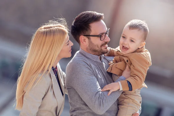 Happy young family in autumn park,having fun.