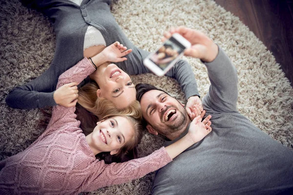 Top View Happy Family Smiling Camera Take Selfie Lying Floor — стоковое фото