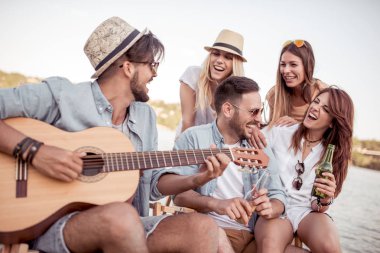 Sahilde eğleniyor ve soğuk bir bira içme arkadaş.