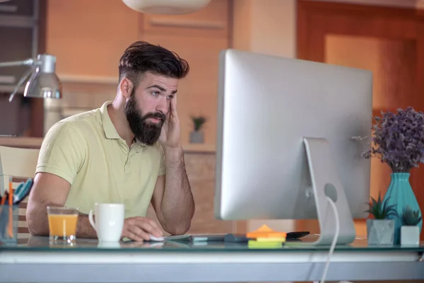 Young man at home using a computer,freelance developer or designer.