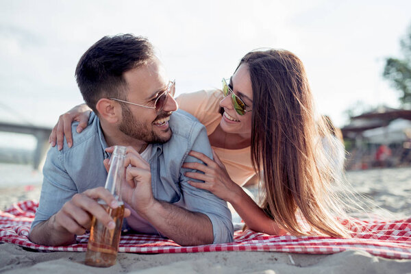 Portrait of happy couple on the beach, having fun.