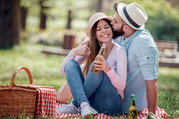 Portrait of a happy young couple enjoying a day in the park together.