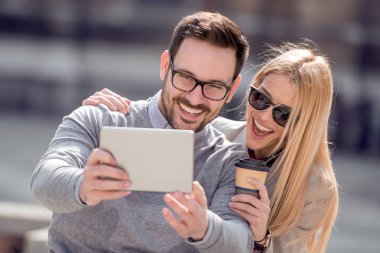 Genç çift şehir sokak tablet kullanma