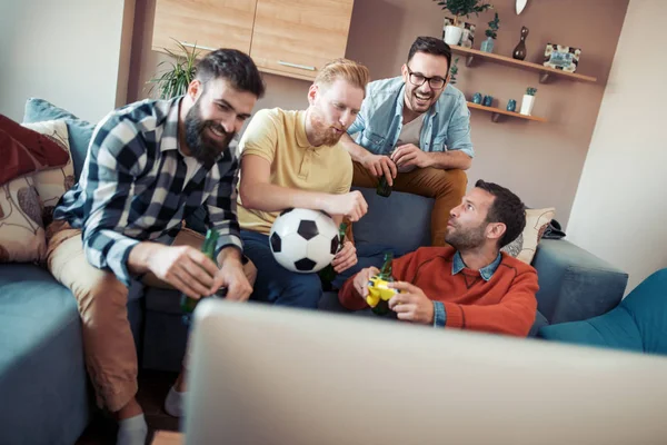 Evde eğlenmek, futbol TV izlerken mutlu erkek arkadaşlar