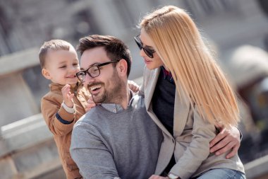 Mutlu genç aile eğleniyor şehirdeki sokak,. 