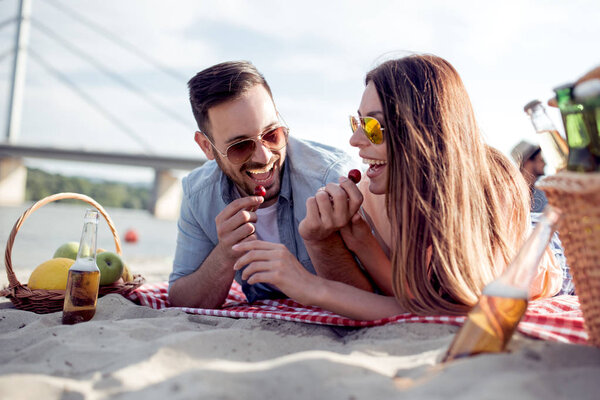 Portrait of happy couple together on the beach, having fun. 